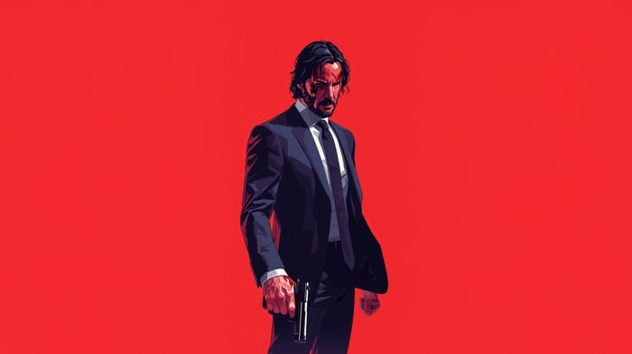 John Wick holding a gun in a suit