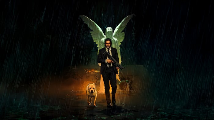 John Wick and dog with angel statue in rain