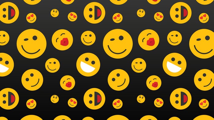 Pattern of yellow emojis on a black background