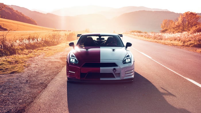 Red and White Nissan GTR on a Road