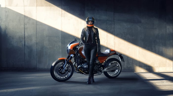 Woman in leather jacket with BMW R 12 S motorcycle