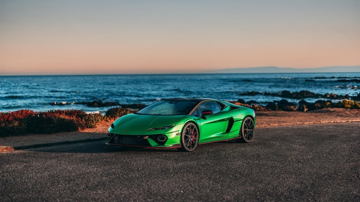 Green Lamborghini sports car by the ocean