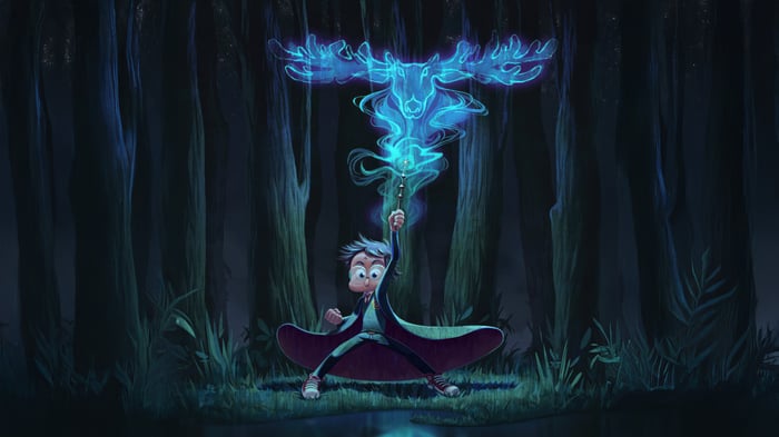 Boy casting a Patronus in a forest