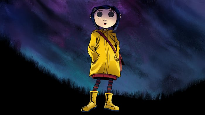 Coraline standing in front of a colorful background