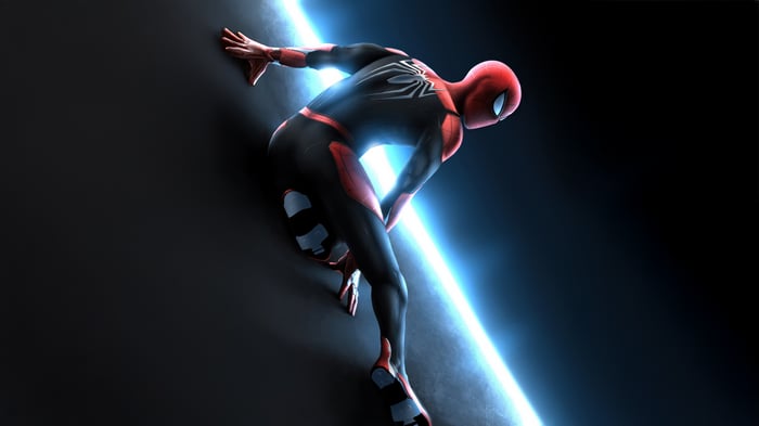 Spider-Man climbing a dark wall with blue light