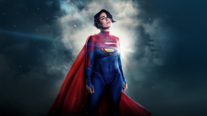 Supergirl in a red and blue suit with a red cape