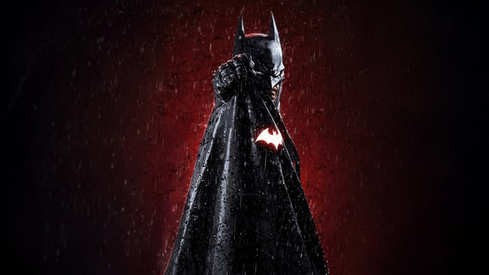 Batman in a wet black cape with a glowing bat symbol