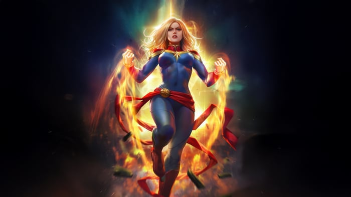 Captain Marvel surrounded by fire and light