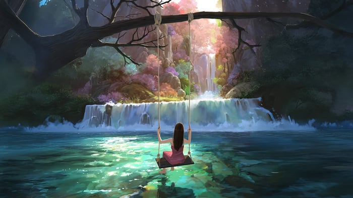 Girl on a swing in front of a waterfall