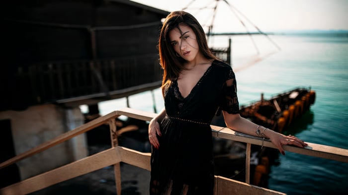 Girl in black dress on a pier