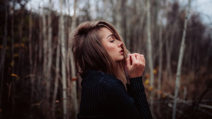 Girl in a dark sweater in the woods