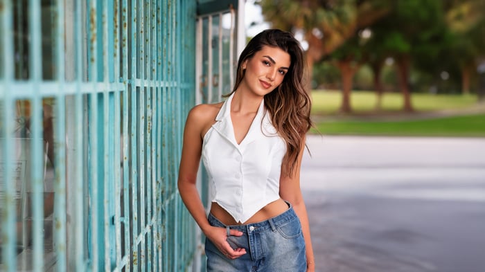 Woman in white halter top and denim skirt