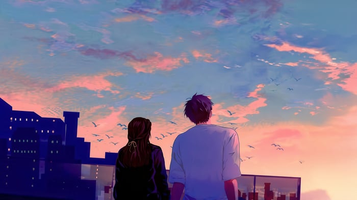 Couple watching a romantic sunset over a city skyline