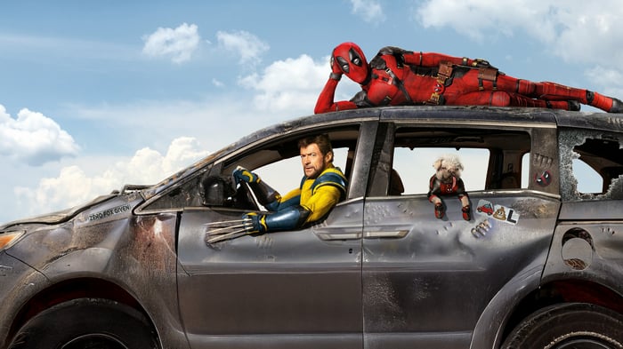 Deadpool and Wolverine on a damaged car