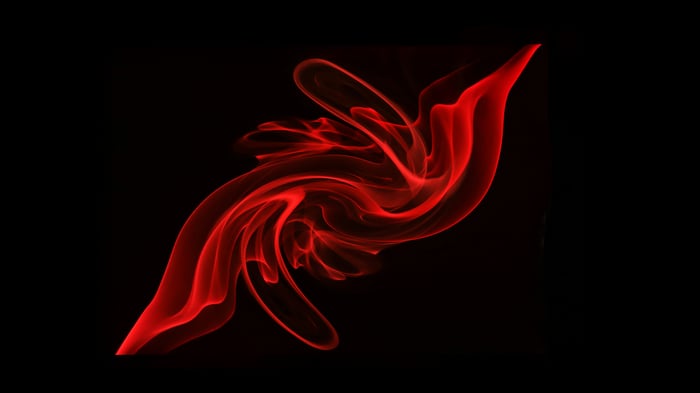 Abstract red smoke swirls on black background