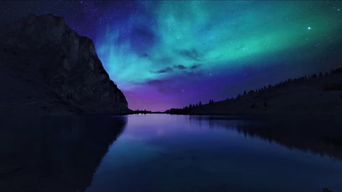 Aurora Borealis over a mountain lake