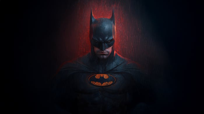 Batman in a black suit with orange emblem