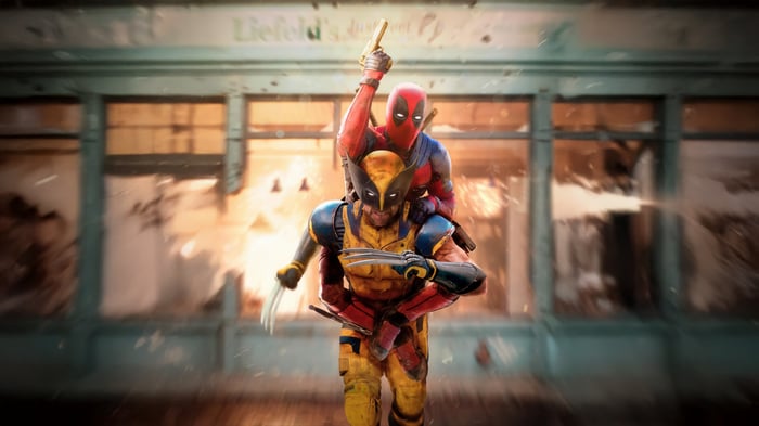Deadpool riding Wolverine in front of a building