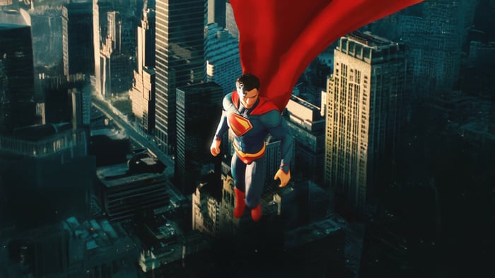 Superman flying over a city with his cape