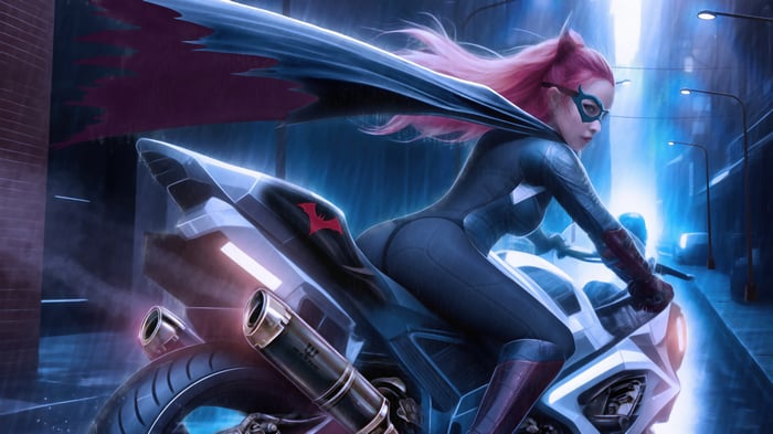 Batwoman on a motorcycle at night