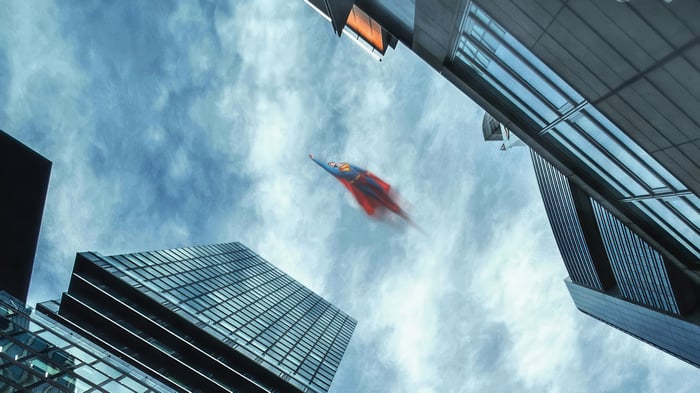 Superman flying between skyscrapers