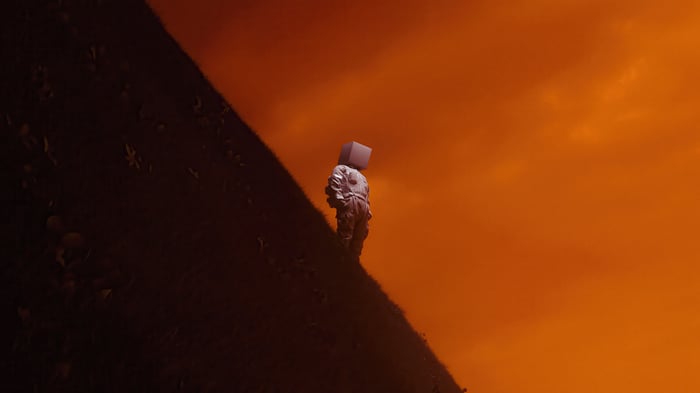 Tv Head Man on a Hill Under Orange Sky