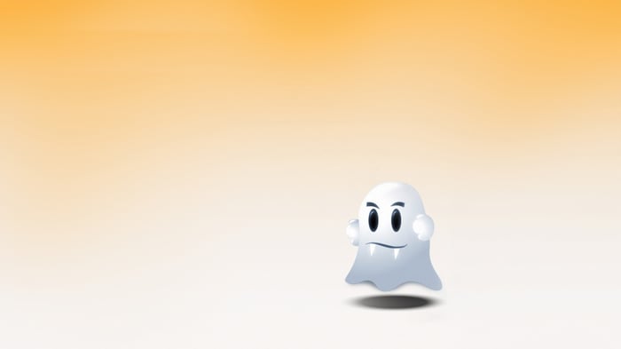 A cartoon ghost with fangs and angry eyes