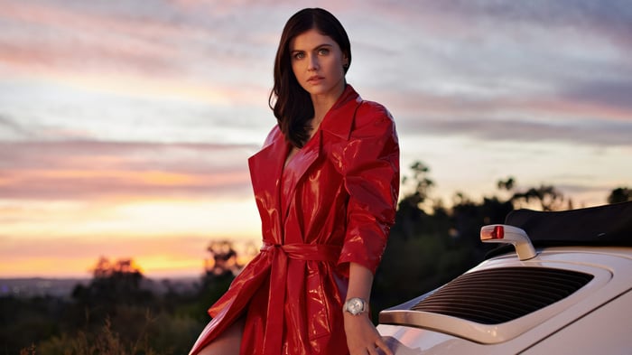 Alexandra Daddario in Red Coat with Porsche