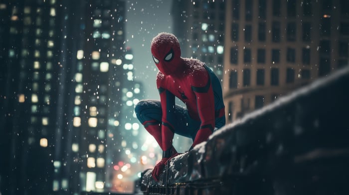 Spiderman crouches on a ledge in a snowy city