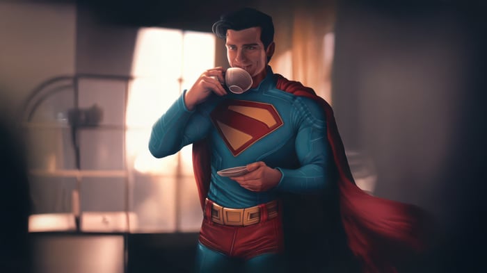 Superman drinking coffee indoors