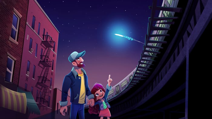 Father and daughter look at a glowing object in the night sky