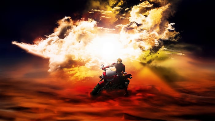 Man riding a motorcycle through clouds