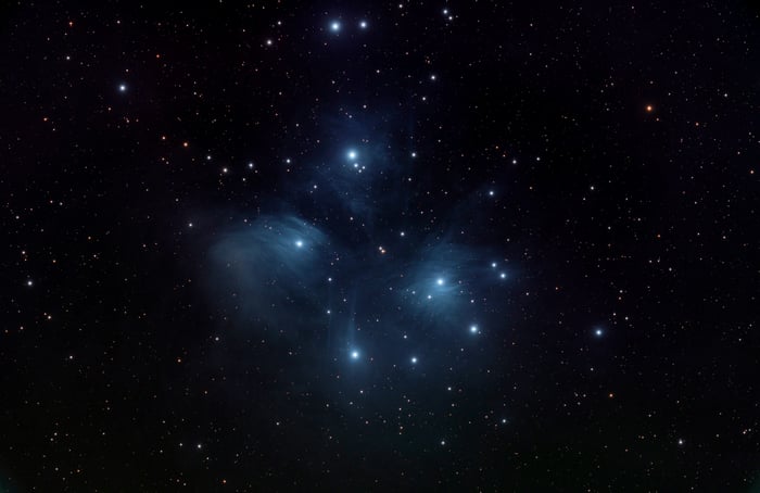 Pleiades star cluster illuminating the night sky
