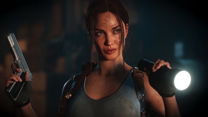 Lara Croft holding a gun and flashlight