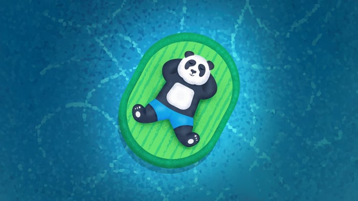 Panda relaxing on a raft in blue water