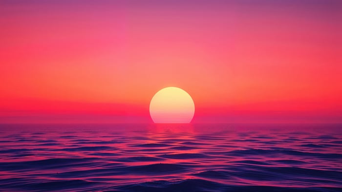 Sunset over the ocean with pink and orange sky