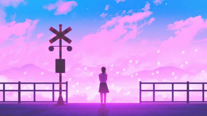 Girl at a railroad crossing at sunset