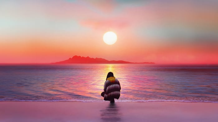 Person watching sunset over the ocean
