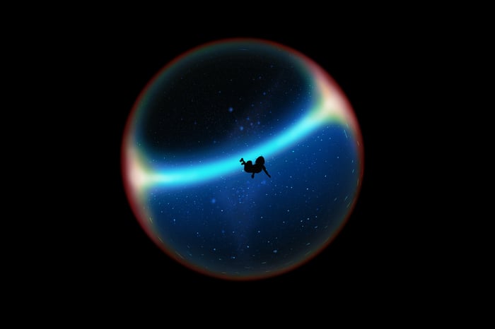 Silhouette falling through a glowing planet in space