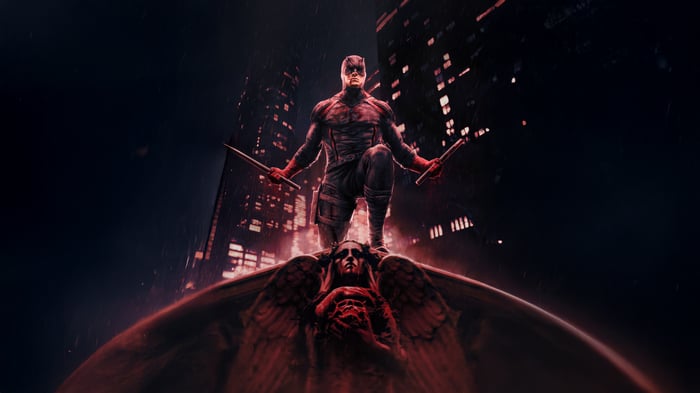 Daredevil standing on a gargoyle in a city at night