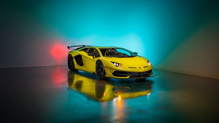 Yellow Lamborghini Aventador SVJ on a reflective surface