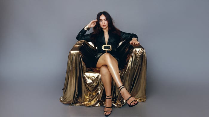 Olivia Cooke in a gold chair