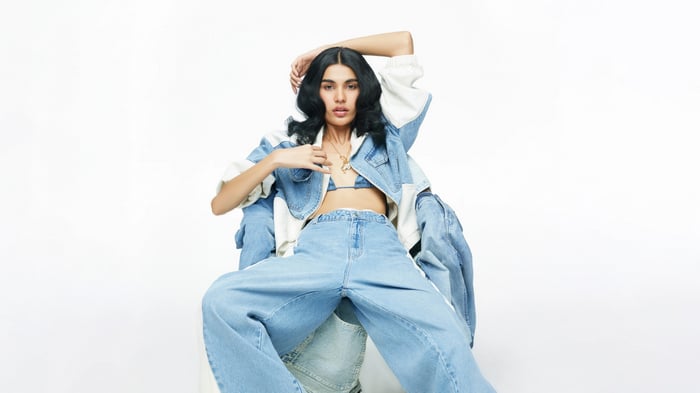 Woman in denim outfit sitting on chairs