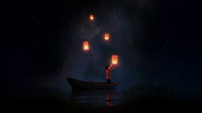 Child Releasing Lanterns into Starry Night Sky