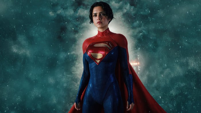 Supergirl in a blue and red suit with a cape