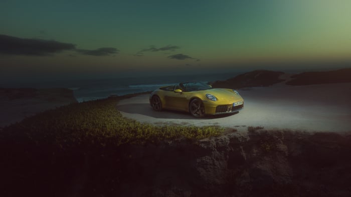Yellow Porsche 911 convertible on a coastal road