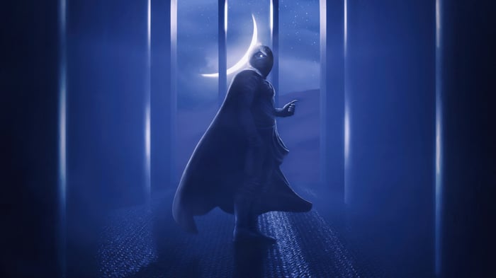 Moon Knight stands in a blue, moonlit hallway