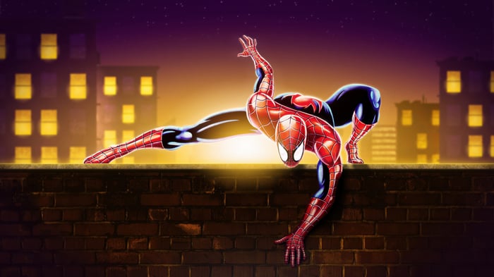 Spider-Man perched on a brick wall at night