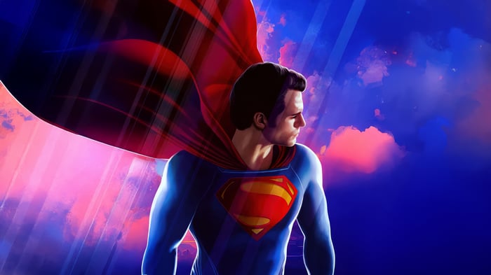 Superman in a red cape against a colorful sky