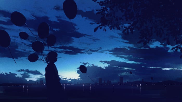Girl with balloons at dusk over city